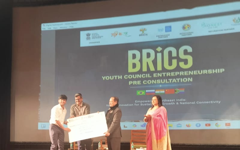 Receiving an oversized cheque on stage at the BRICS Youth Council Entrepreneurship Pre-Consultation